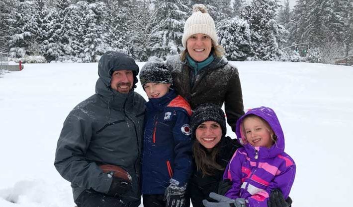 Brazilian au pair poses in the snow with host family