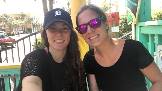 Au pair poses with host mother at an amusement park
