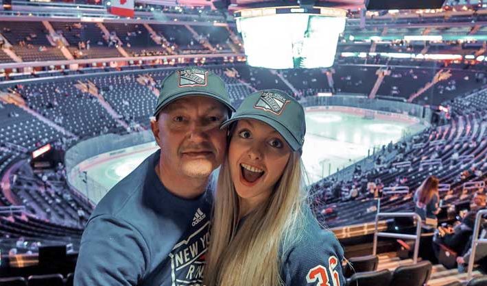 Father and daughter in an ice hockey arena