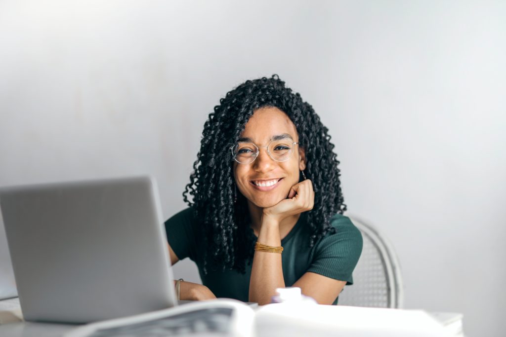 Woman smiles while doing her taxes