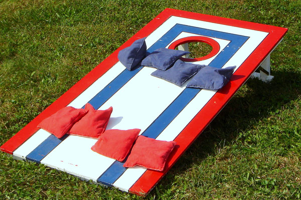 A cornhole board with red, white, and blue paint.