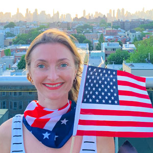 A woman holds a U.S. flag on Independence Day.