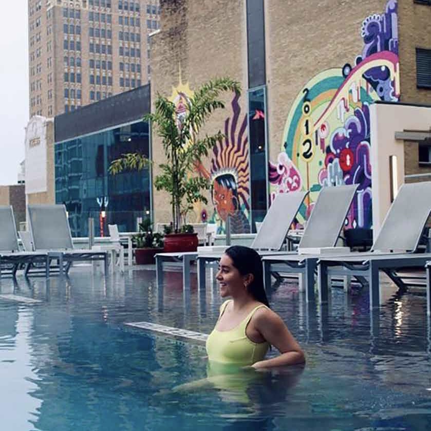 An au pair in a swimsuit in a rooftop pool in San Antonio, Texas.