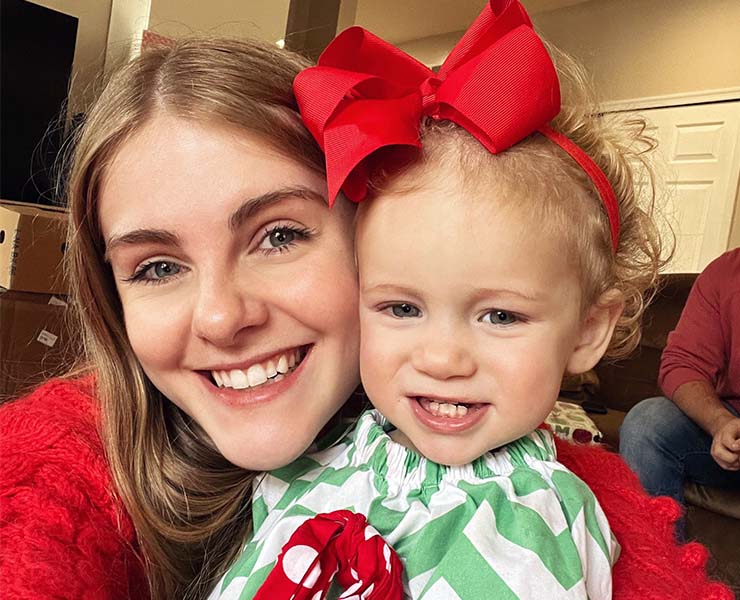 An au pair smiles with a host child.