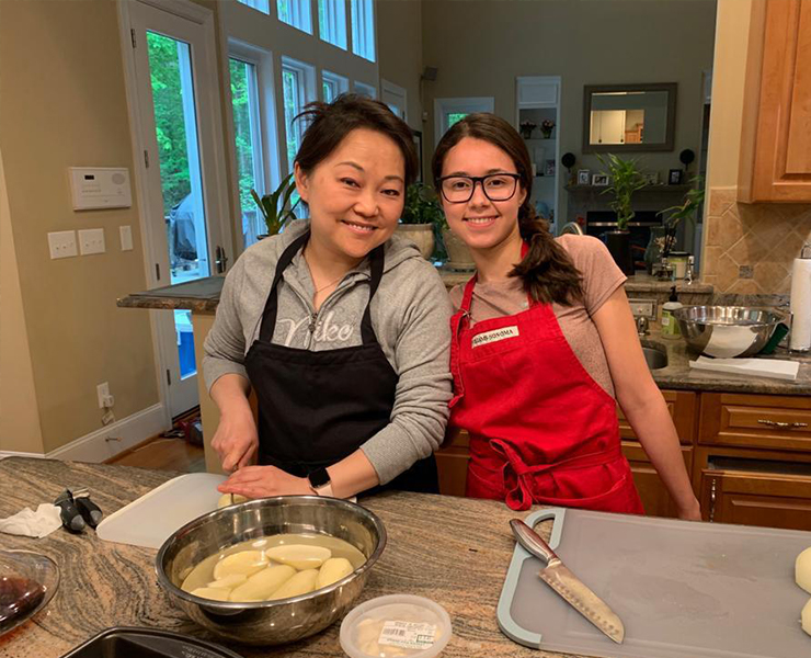 An au pair helps her host mom cook on Mother's Day.