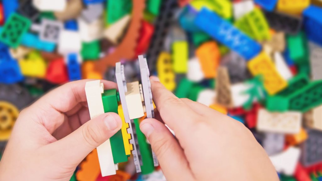 Host children playing legos with au pair