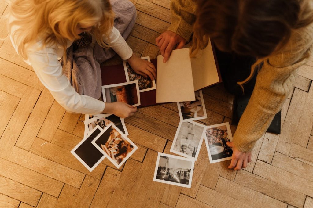 Woman and child looking at polaroids.