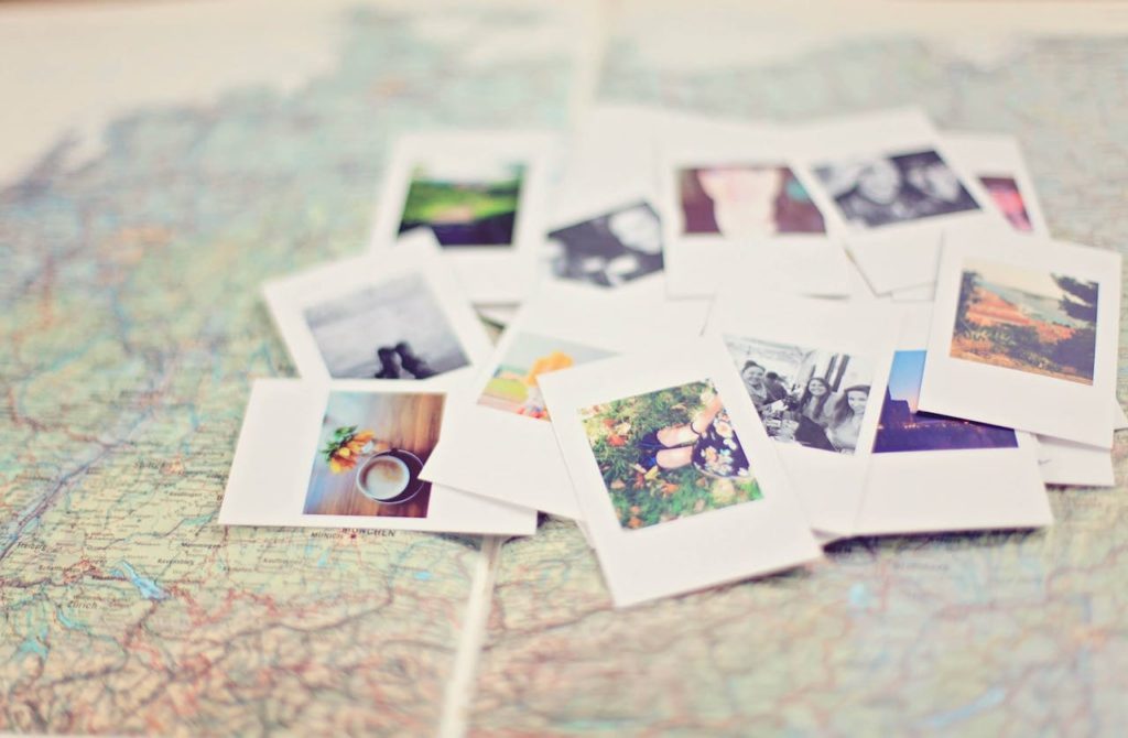 Stack of polaroids on top of a map.