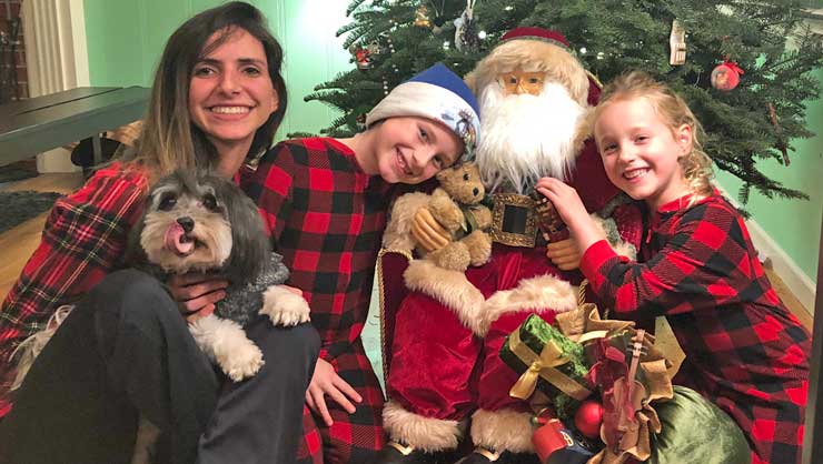 Au pair Carolina and her host kids celebrate traditions on Christmas morning.