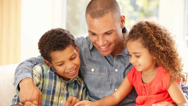 Young man reading to two children