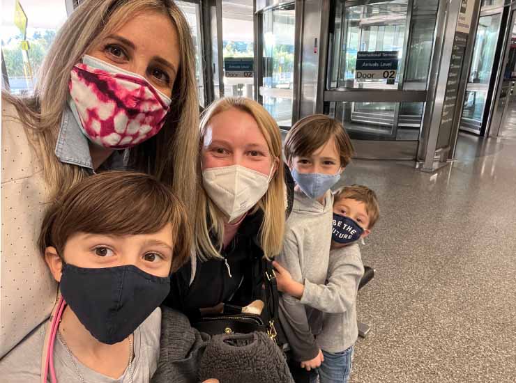 An au pair reunion with a host family at an airport.