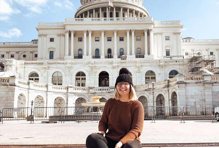 A German au pair sits near the U.S. Capitol Building.