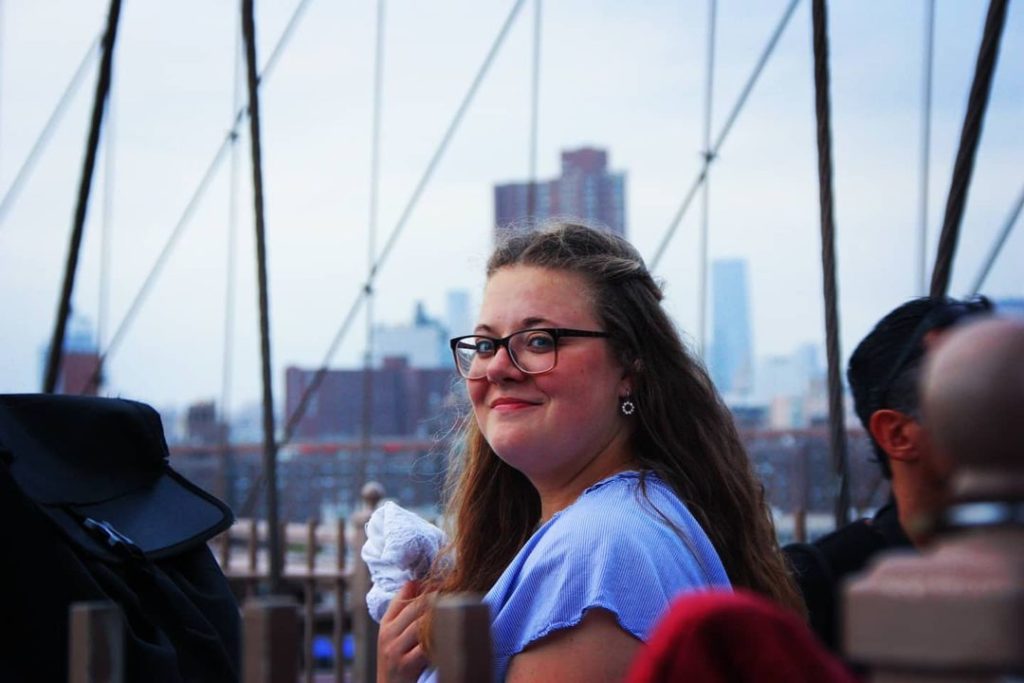 A German au pair poses near a bridge in New York City.