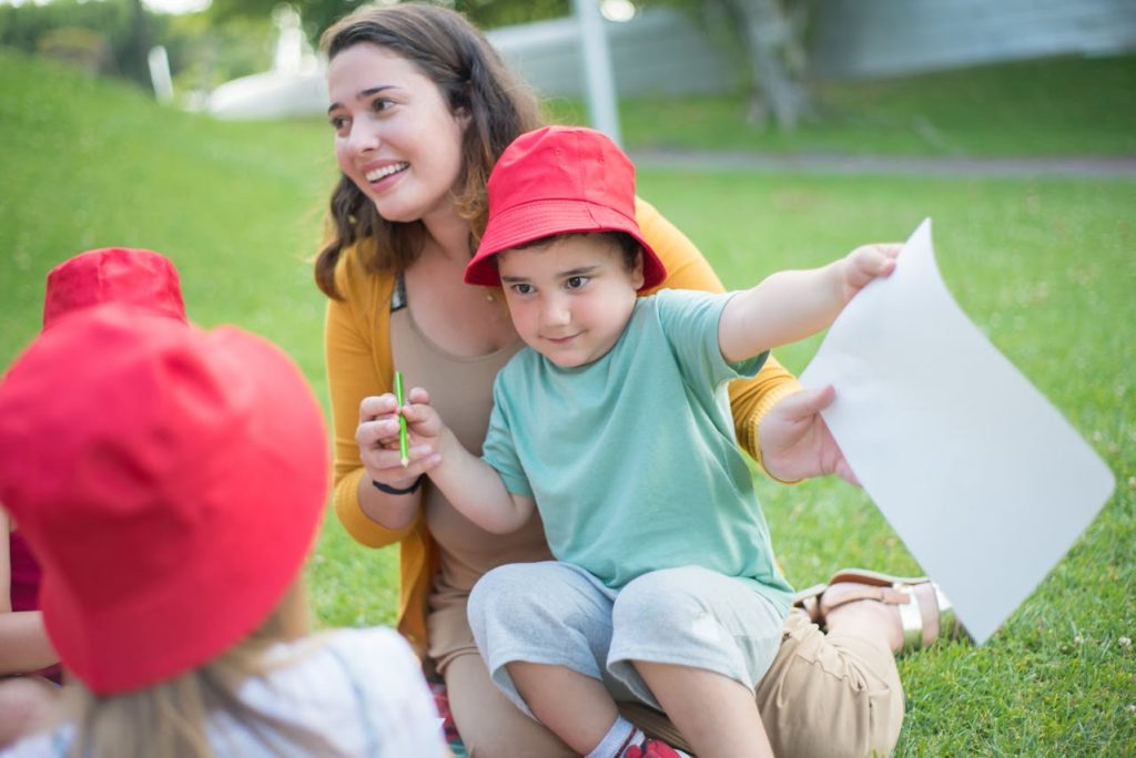 A woman surrounded by kids in the park. 