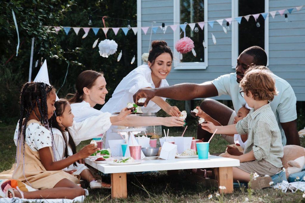 A mixed family having a picnic outside. 